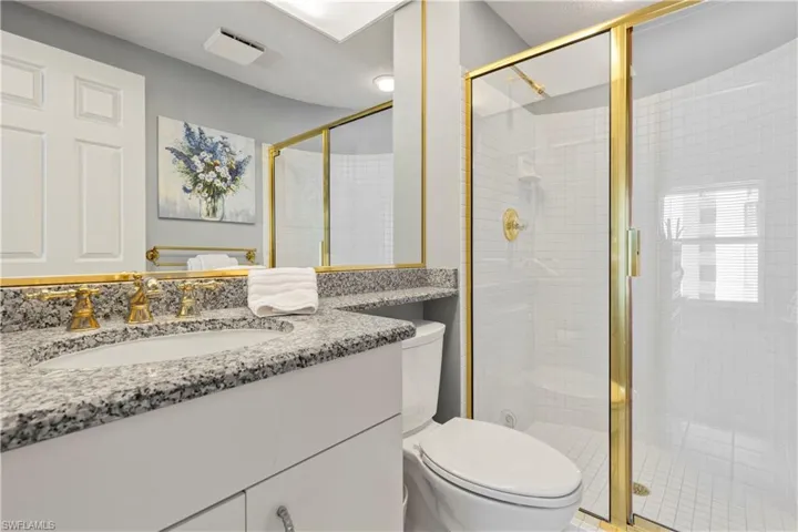 Bathroom featuring vanity and a shower stall