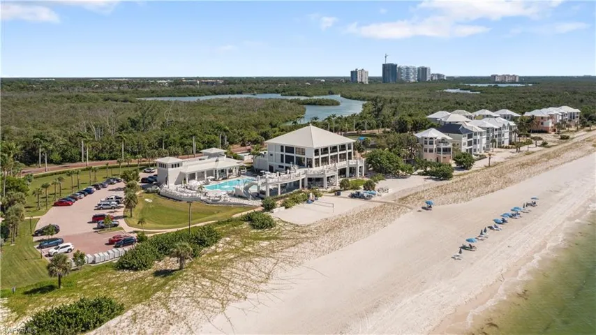 Drone / aerial view of the Private Barefoot Beach Club with waterfront dining and pool