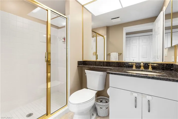 Full bathroom featuring vanity and a shower stall