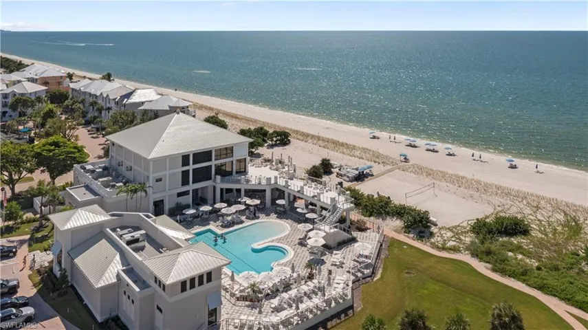 Drone / aerial view of expansive beach and Barefoot Beach Club with dining, pool and bar