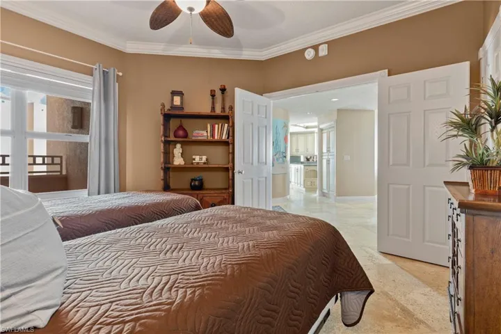 Bedroom featuring ornamental molding and a ceiling fan