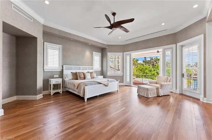 Bedroom with access to outside, baseboards, and hardwood / wood-style floors