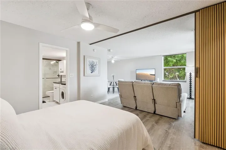 Recessed lighting, wood-finish flooring, full-size window, and a built-in washer