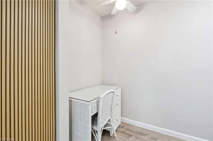 Wood-finish flooring with a white baseboard trim