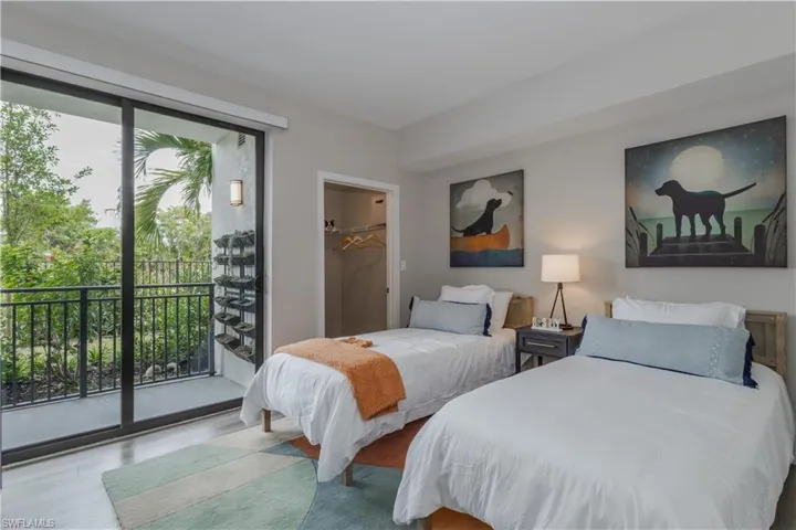Bedroom featuring access to outside and a walk in closet
