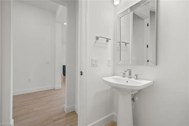 Guest Bathroom featuring hardwood / wood-style flooring and sink