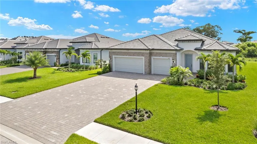 View of front of house with a garage and a front lawn