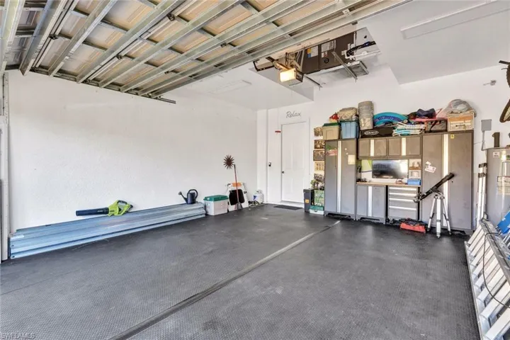 Garage with a garage door opener and gas water heater