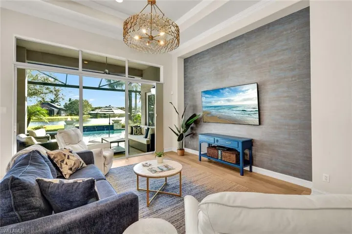 Living room featuring ornamental molding, a chandelier, and hardwood / wood-style flooring