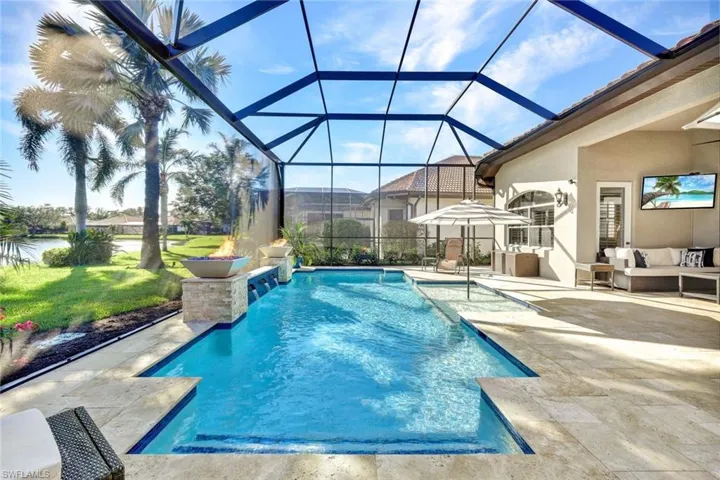 View of swimming pool featuring a lanai, a lawn, a patio, and an outdoor hangout area