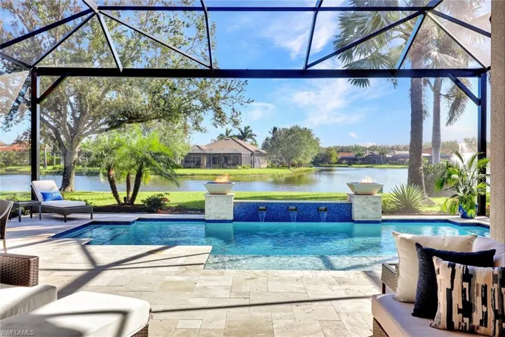 View of swimming pool featuring a lanai, a patio area, and a water view