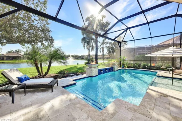 View of pool featuring a water view, a patio area, and a lanai