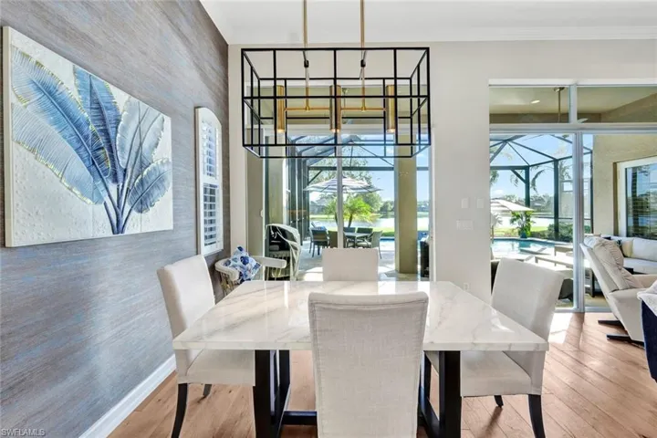 Dining room featuring hardwood / wood-style floors and ornamental molding
