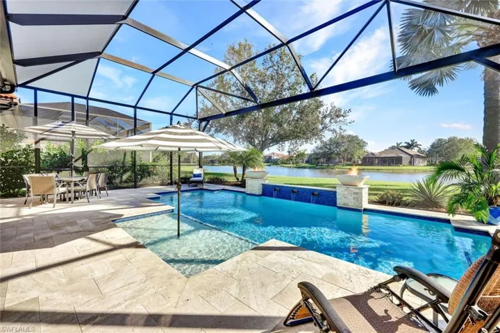 View of pool with a lanai, a water view, and a patio