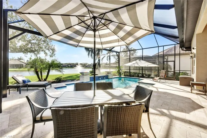 View of patio with a water view and glass enclosure