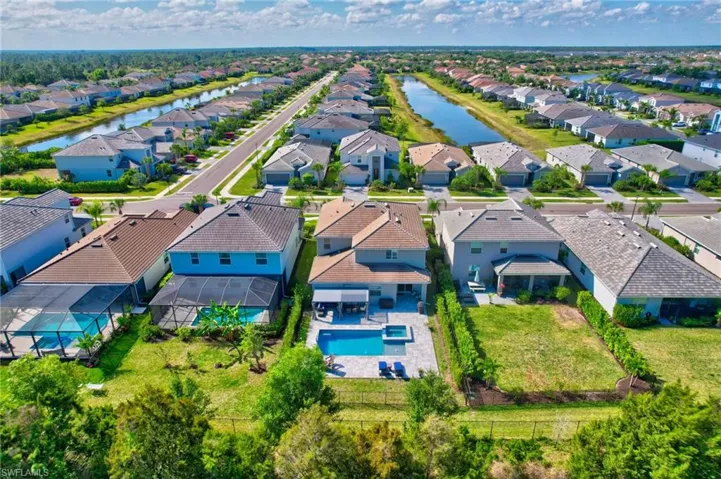 Drone / aerial view with a water view and a residential view