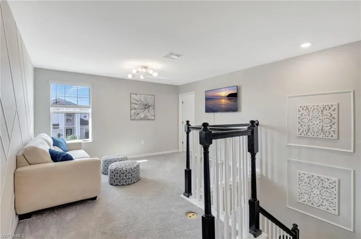 Upstairs loft, carpet floors, and an inviting chandelier