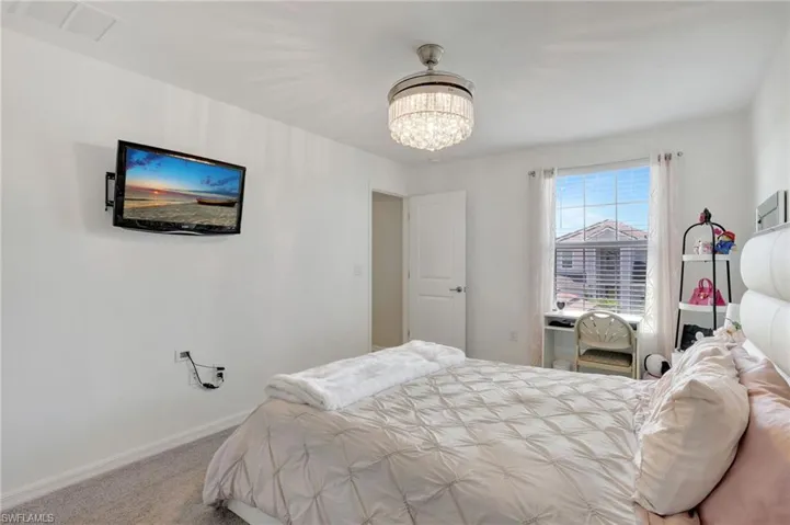 Bedroom featuring baseboards, a notable chandelier, visible vents, and carpet