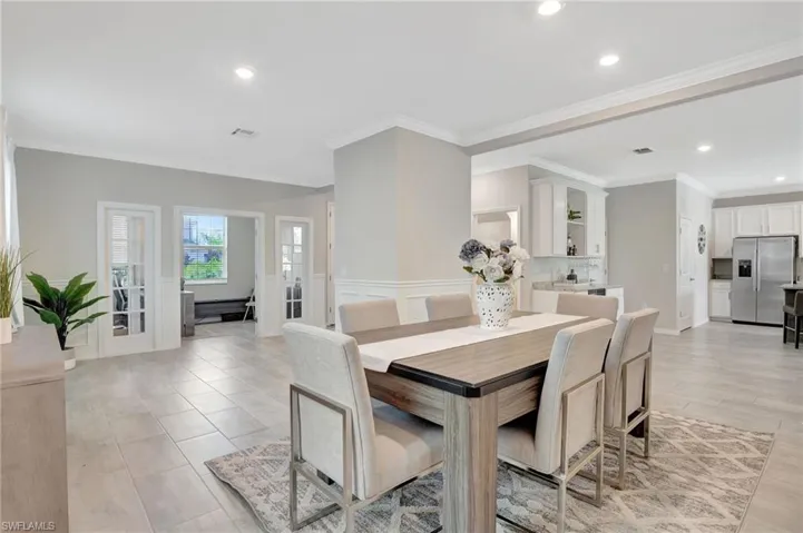 Dining area with visible vents, ornamental molding, and recessed lighting