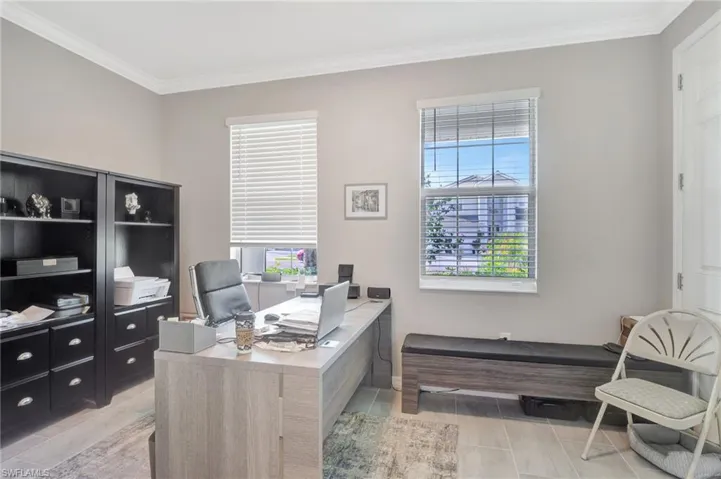 Office space featuring crown molding and a healthy amount of sunlight