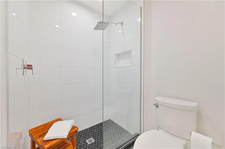 Full bathroom featuring toilet and tiled shower