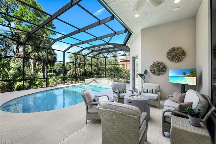 Featuring covered seating area and new travertine patio surface, new raised spa and new pool surface