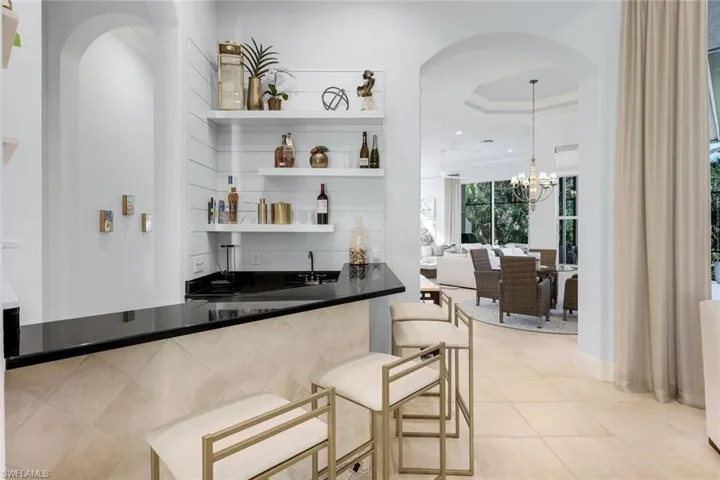 Entertainment center with beverage refrigerator and sink