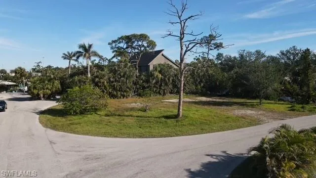 View of home's community with a lawn