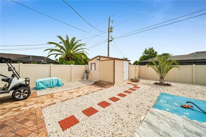 View of yard with a storage unit and a patio