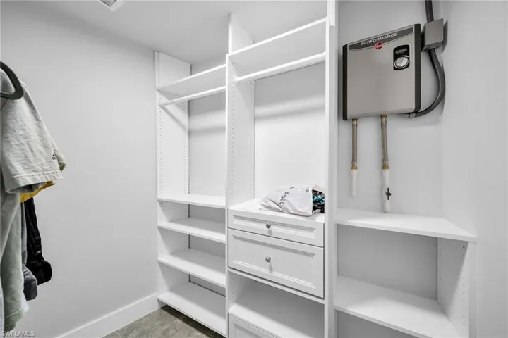 Walk in closet with dark tile patterned floors