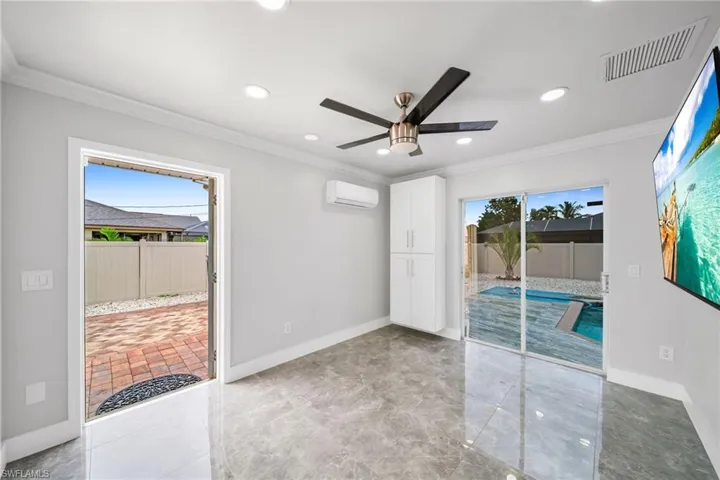 Spare room featuring crown molding, an AC wall unit, and ceiling fan