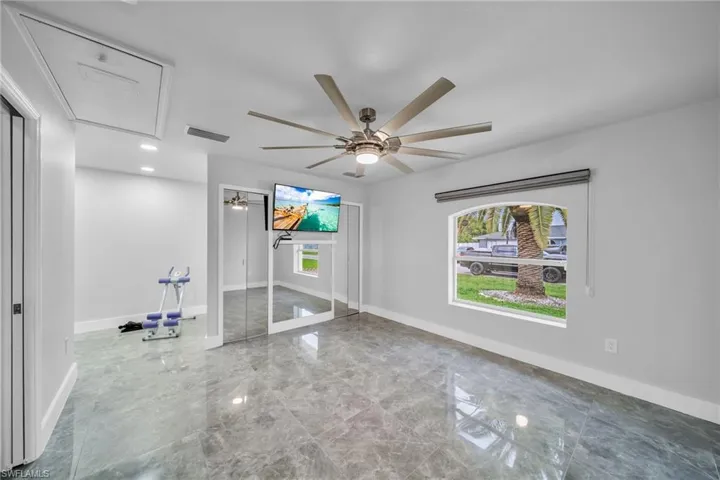 Unfurnished living room with ceiling fan