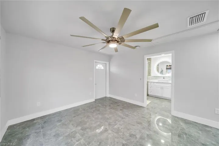 Unfurnished room with ceiling fan and sink