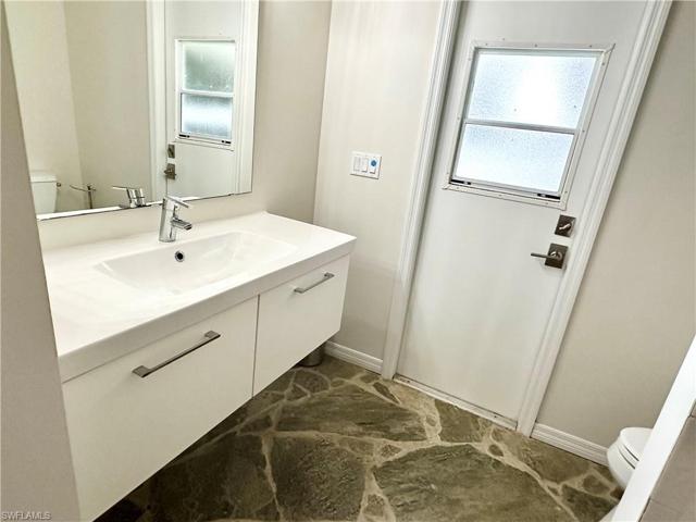 Perfect pool to be bathroom with access to outside. Floating sink