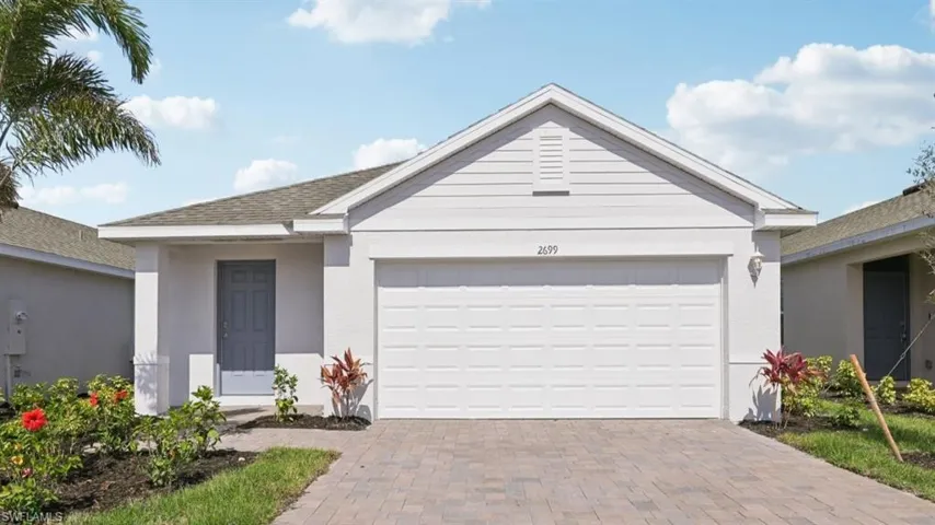 This image is virtually staged. Single story home with decorative driveway, an attached garage, stucco siding, and a shingled roof