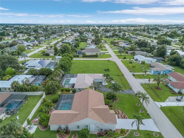 Aerial view of property's location with nearby suburban area