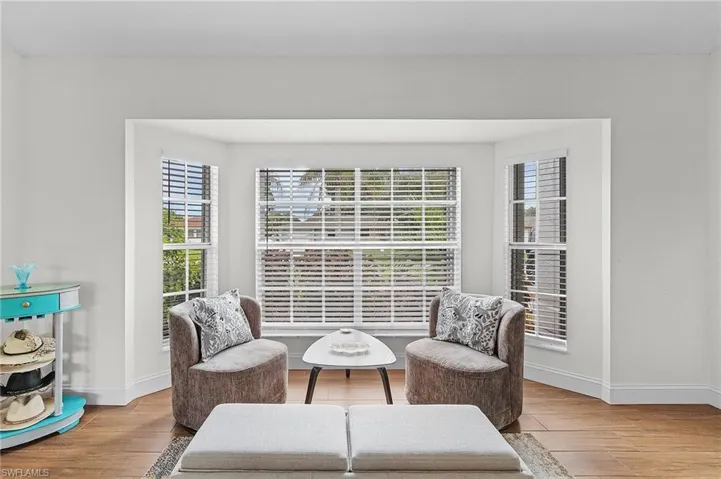Living area with wood finished floors and baseboards