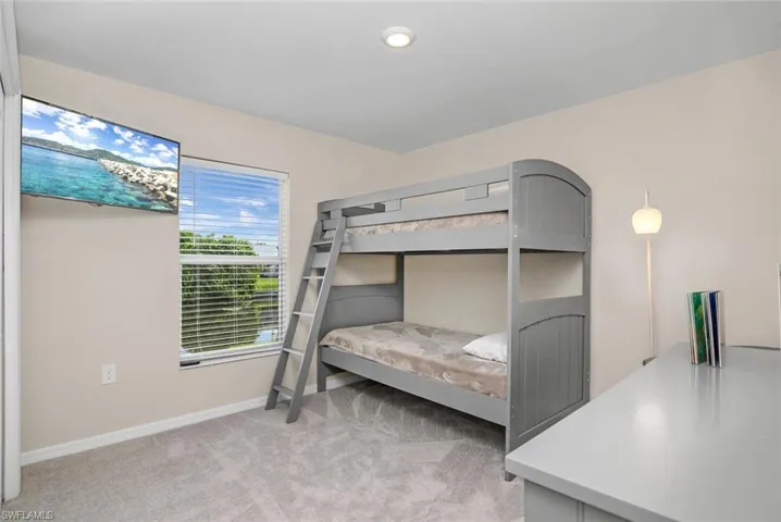 Bedroom with light colored carpet