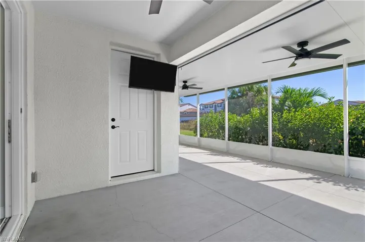 Unfurnished sunroom with ceiling fan