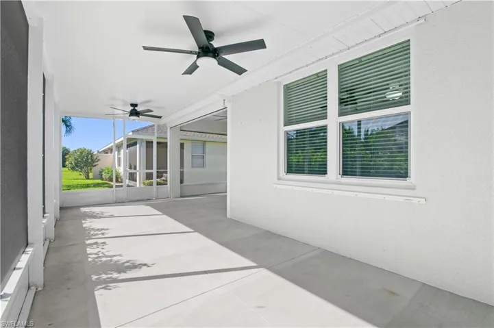 View of patio featuring a ceiling fan and a sunroom