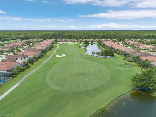 Birds eye view of property with a water view