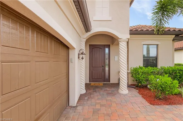 Doorway to property featuring a garage