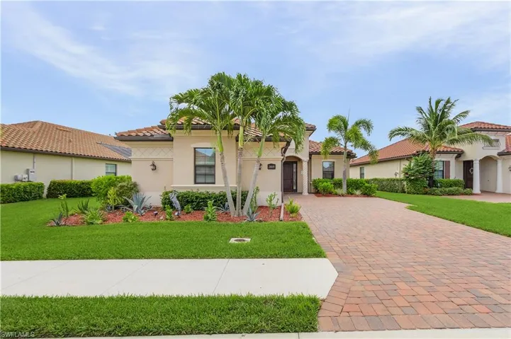 Mediterranean / spanish home featuring a front yard