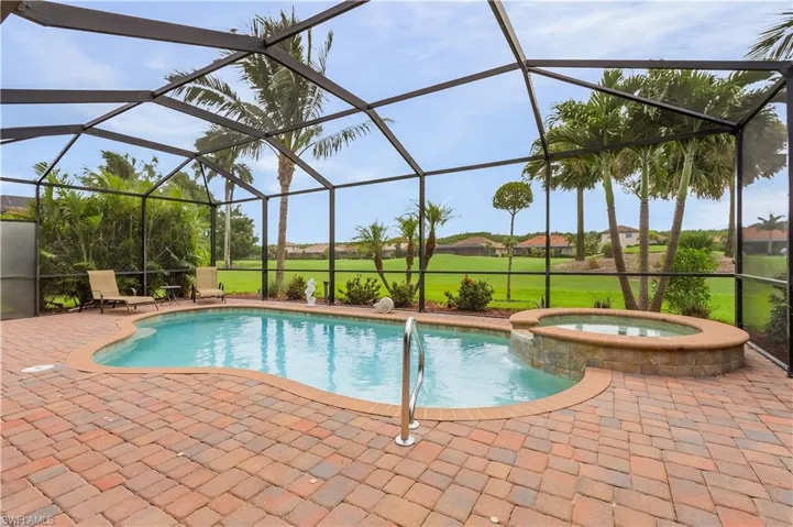 View of swimming pool featuring a patio, an in ground hot tub, and a lanai