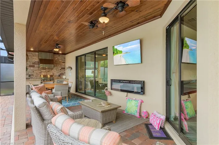View of patio with ceiling fan and outdoor lounge area