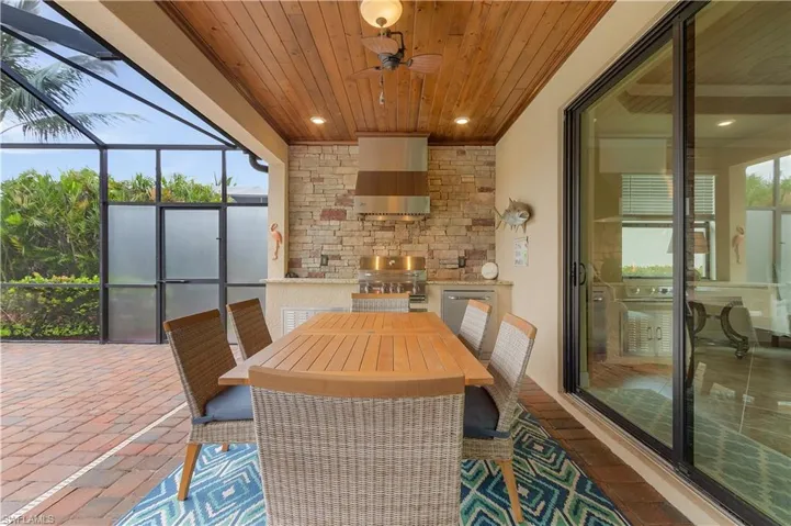 Sunroom / solarium featuring ceiling fan and wooden ceiling