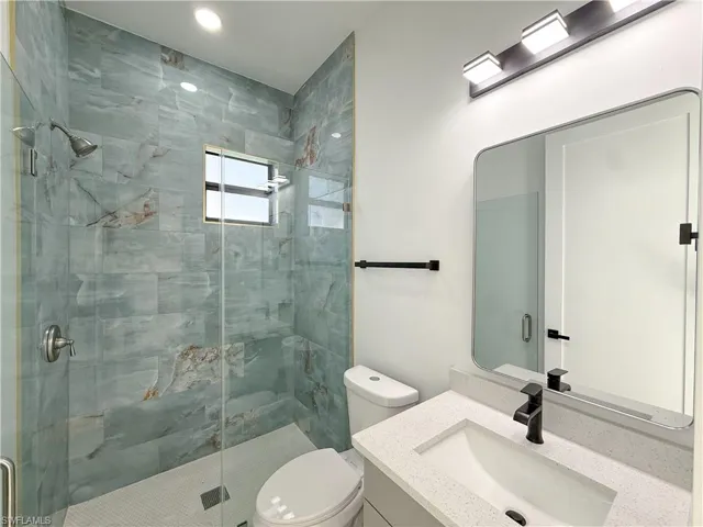 Bathroom featuring vanity and a shower stall