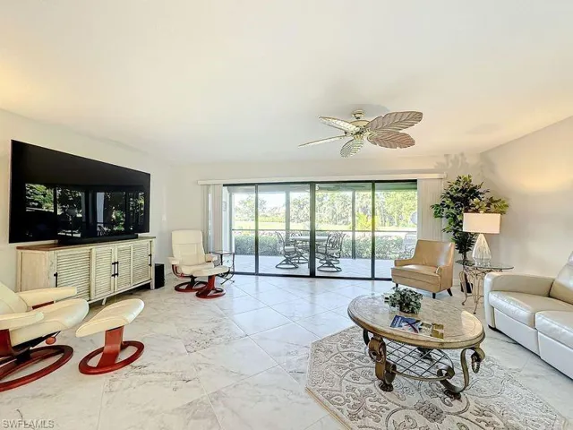 Living room featuring ceiling fan and plenty of natural light