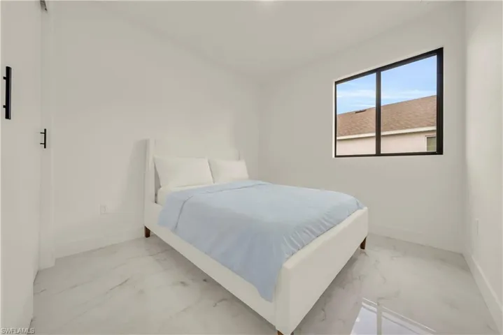 Bedroom with baseboards and marble finish flooring