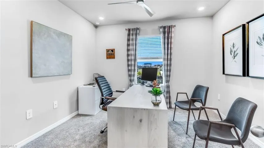Model home. Office space with light carpet, a ceiling fan, and recessed lighting